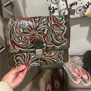 Patricia Nash 
Brown and Turquoise Embossed Leather Crossbody Bag